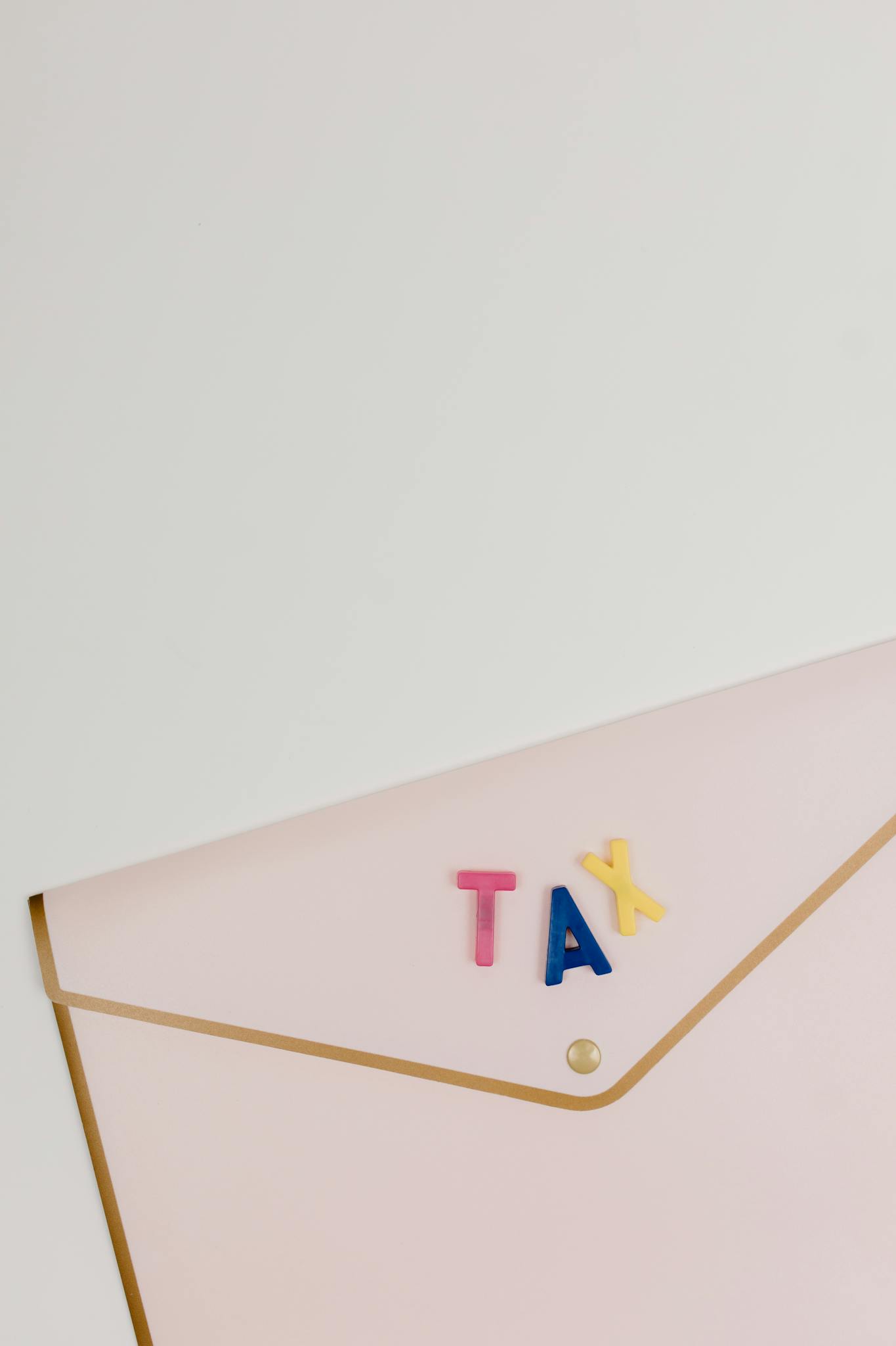 Pink Envelope With Tax Letters Arranged On
